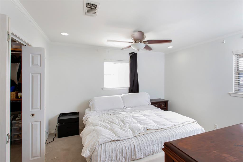 853 Royal Terrace Hurst, TX 76053 - Photo 20 of 34 a bedroom with a bed and a chandelier