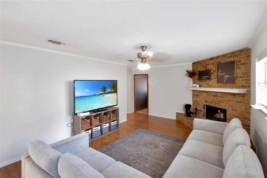 853 Royal Terrace Hurst, TX 76053 - Photo 2 of 34 a living room with furniture a fireplace and a flat screen tv