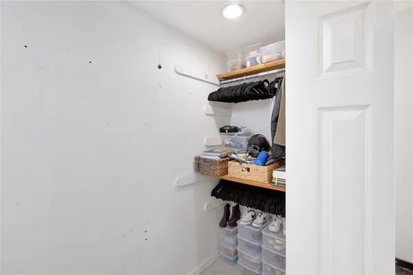 a bedroom with a bed and a ceiling fan