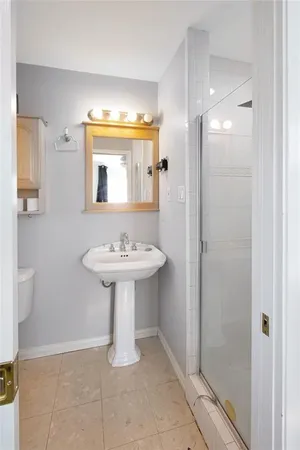 a bathroom with a glass shower door