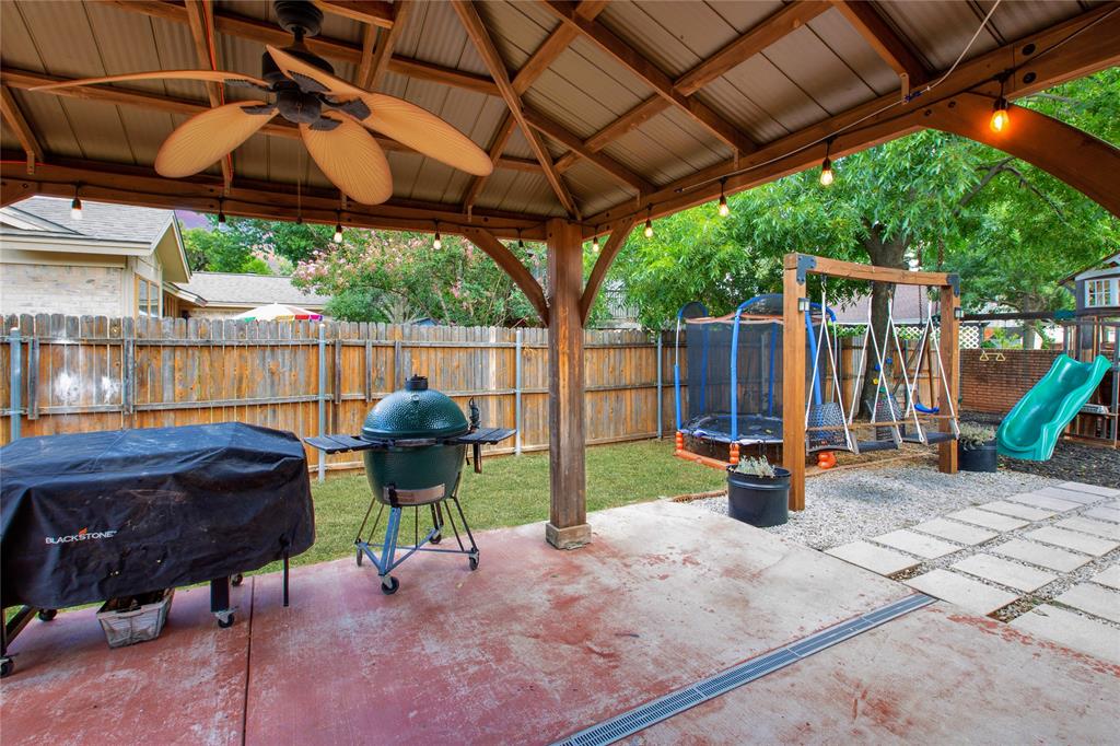 853 Royal Terrace Hurst, TX 76053 - Photo 29 of 34 a view of a patio with a table and chairs under an umbrella with a sink