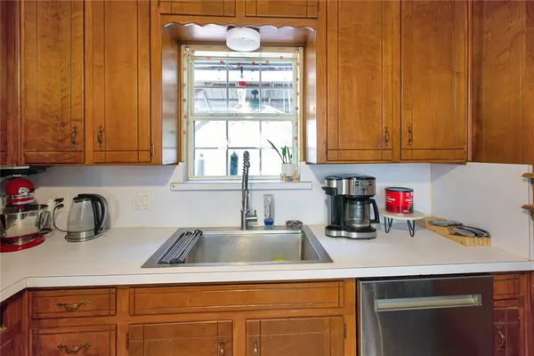 a kitchen with a sink cabinets and a window