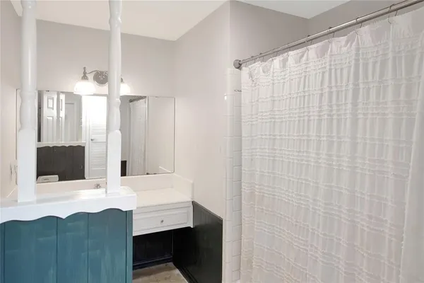 a bathroom with a sink a mirror and a shower