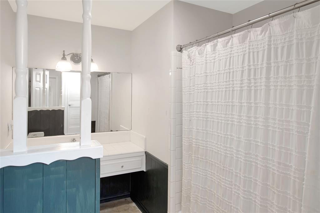 853 Royal Terrace Hurst, TX 76053 - Photo 10 of 34 a bathroom with a sink a mirror and a shower