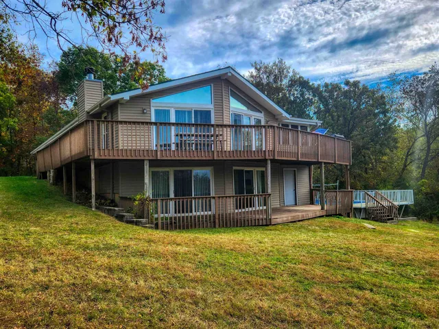 a view of a house with swimming pool and sitting area