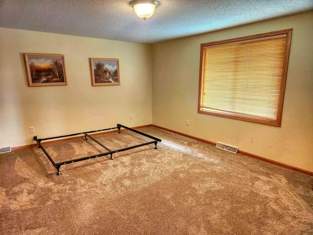 a view of a room with gym equipment and a window