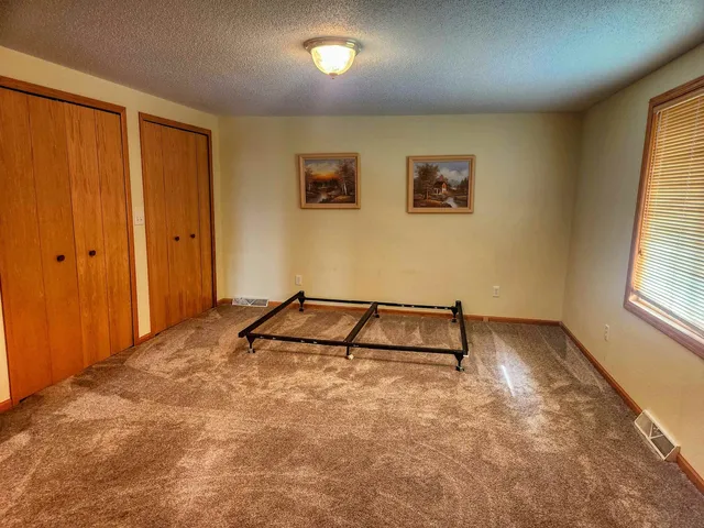 a room with a wooden floor and a window