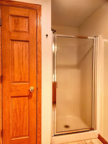 a bathroom with a glass shower door