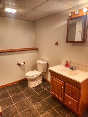 a bathroom with a toilet sink and mirror