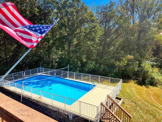 a view of a tennis court with two chairs