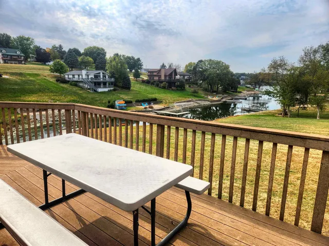 a view of a balcony with wooden floor & fence