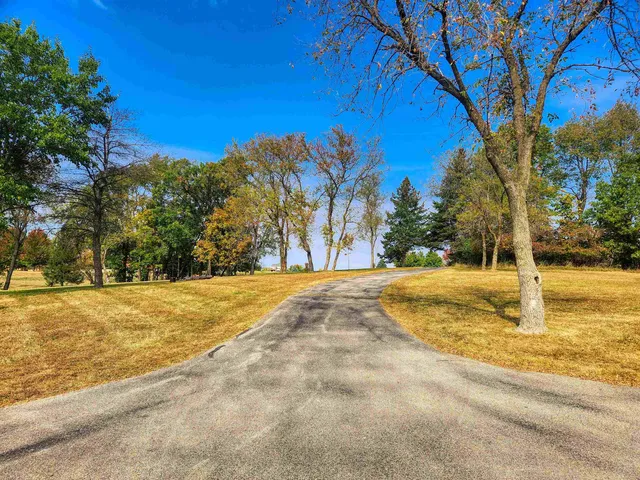 a view of yard with swimming pool and trees