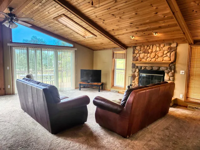 a living room with furniture a fireplace and a flat tv