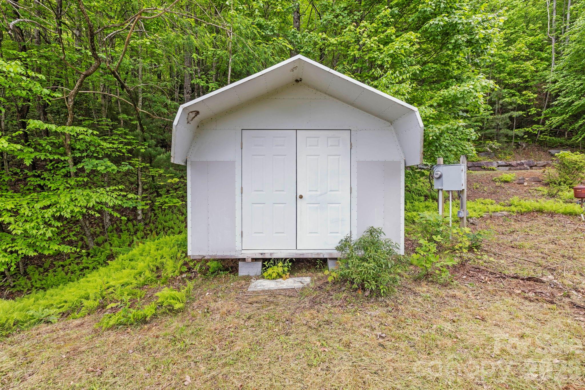 1325 Golden Road Lake Toxaway, NC 28747 - Photo 15 of 15 a front view of a house with garden