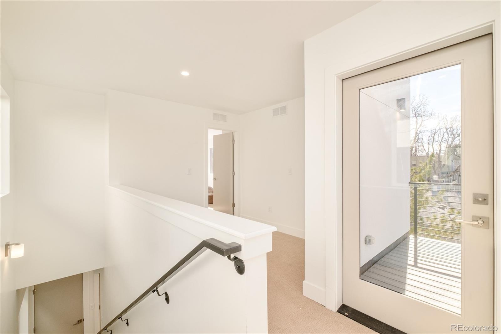 2357 South High Street Denver, CO 80210 - Photo 14 of 41 a view of a hallway with windows