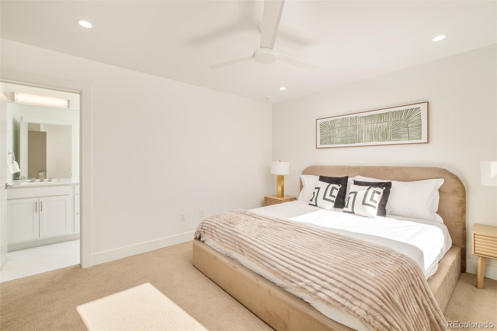 2357 South High Street Denver, CO 80210 - Photo 18 of 41 a bedroom with a bed and a painting on the wall