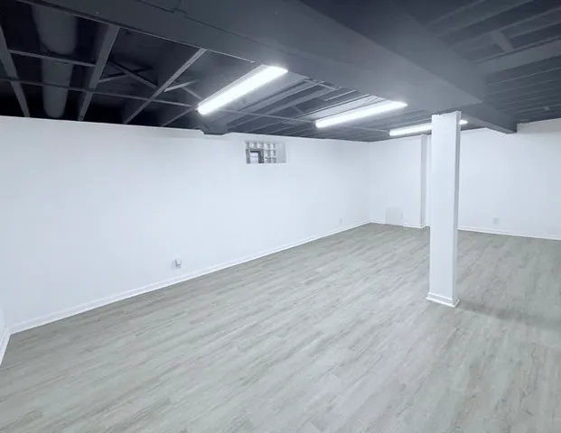 an empty room with wooden floor