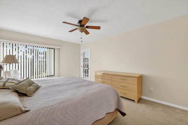a view of a patio with a table and chairs under an umbrella