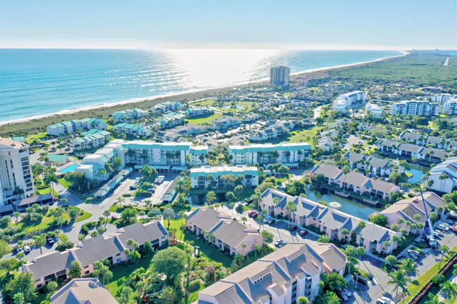 a front view of a building with a garden