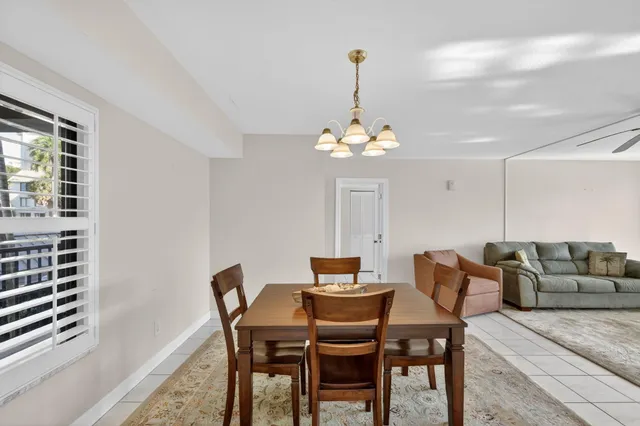 a kitchen with granite countertop white cabinets white stainless steel appliances and a sink
