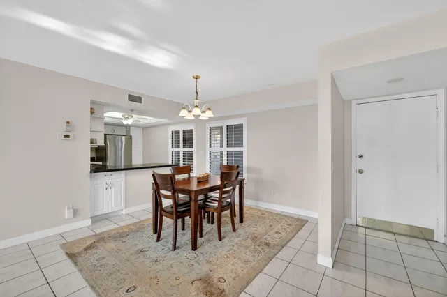 a kitchen with stainless steel appliances granite countertop a sink a stove a refrigerator a microwave and cabinets