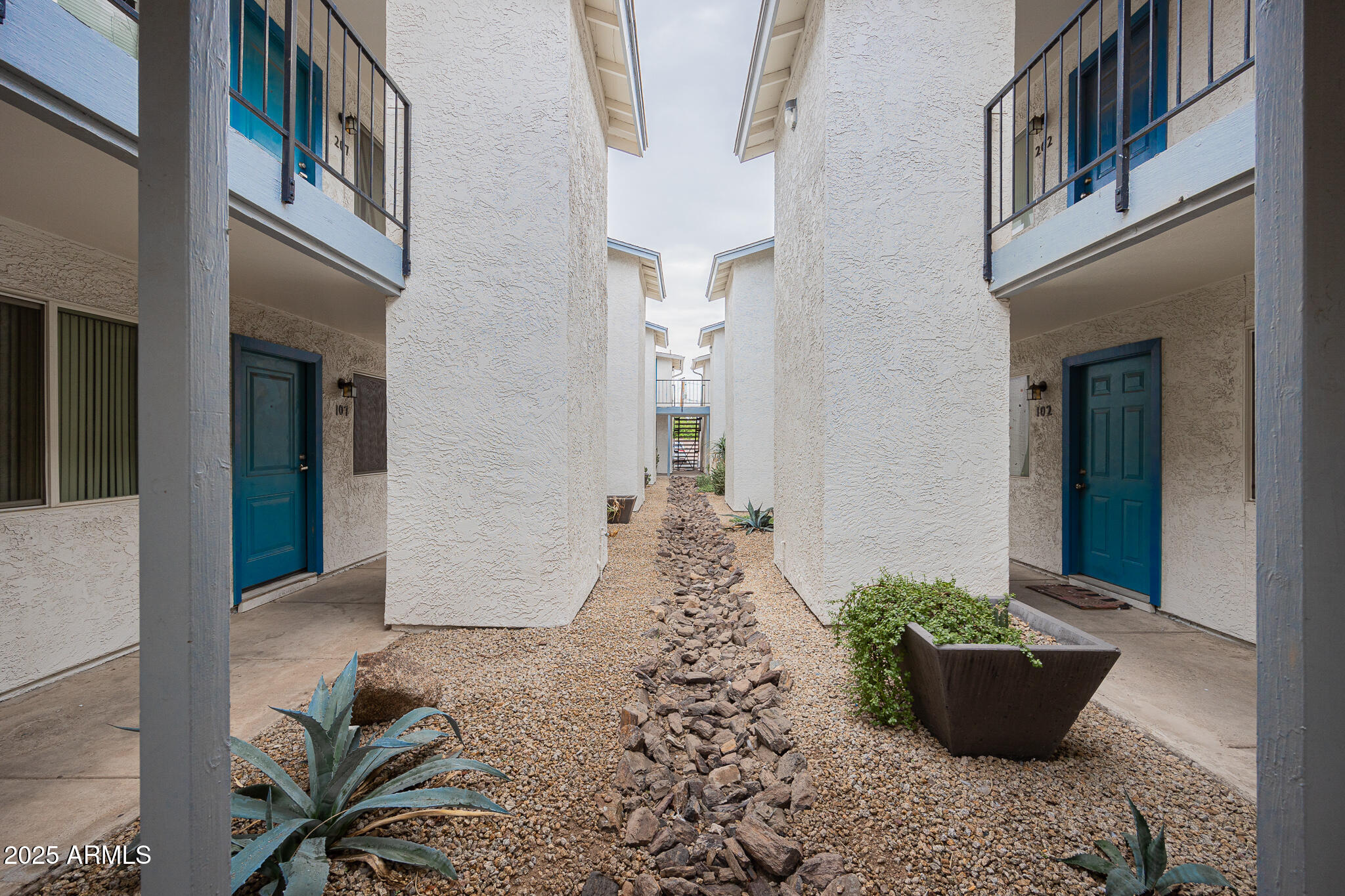 349 North 11th Street, Unit 110 Phoenix, AZ 85006 - Photo 1 of 18 a front view of a house with potted plants