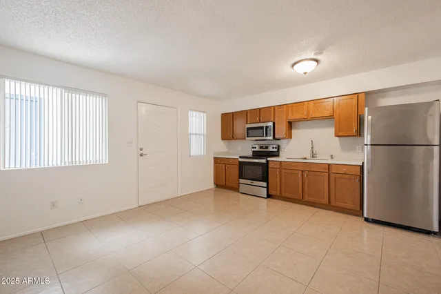 a kitchen with stainless steel appliances a refrigerator and a sink
