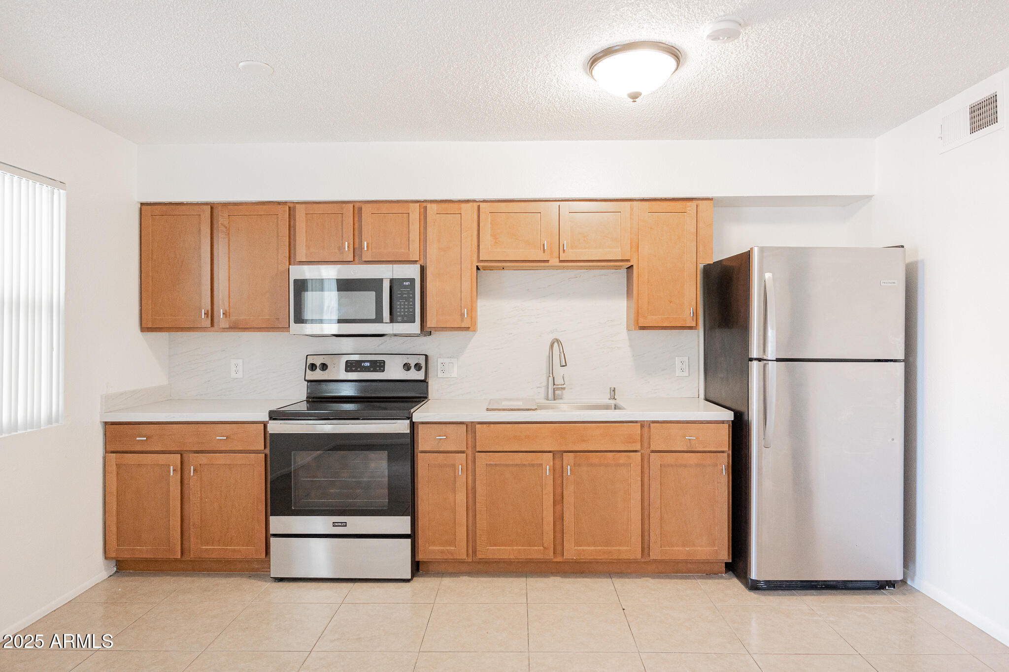 349 North 11th Street, Unit 110 Phoenix, AZ 85006 - Photo 10 of 18 a kitchen with a refrigerator sink and microwave