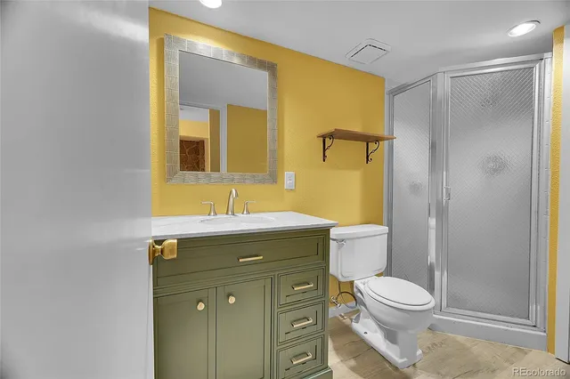 a bathroom with a sink mirror vanity and toilet