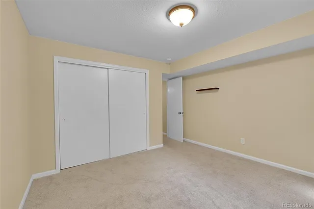 an empty room with closet area