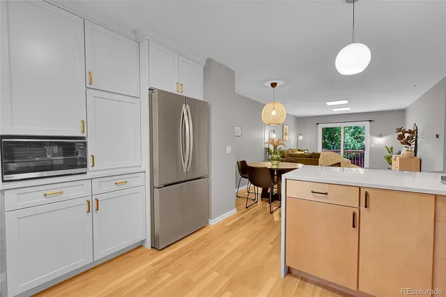 a kitchen with a refrigerator a stove and a sink