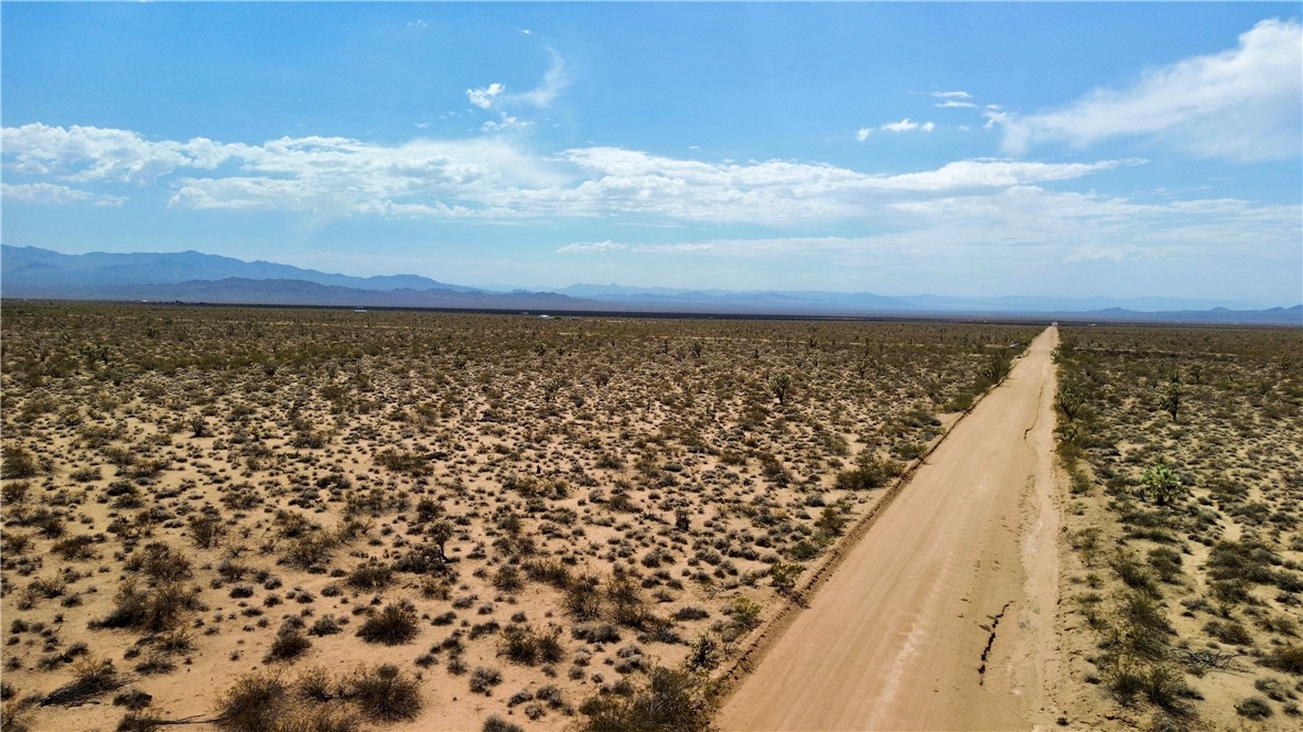 Parcel3177 South Butch Cassidy Road Yucca, AZ 86438 - Photo 8 of 9 Aerial view of sparsely populated area featuring a mountainous background and a desert landscape