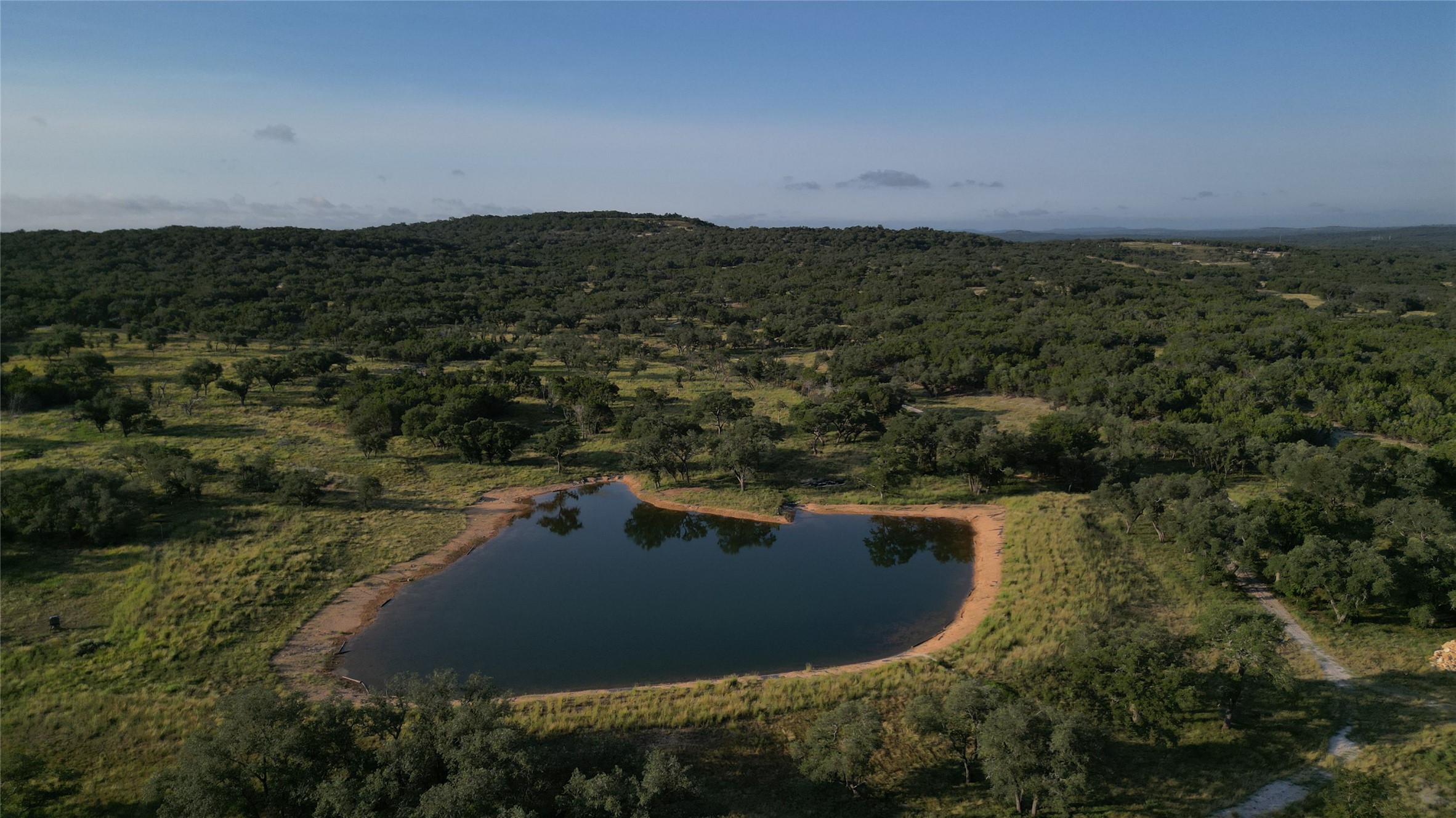 a view of a lake in middle of forest