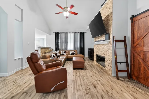 a living room with fireplace furniture and a flat screen tv