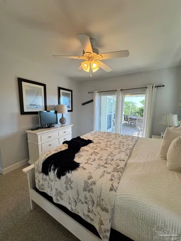 a bedroom with a bed dresser and window