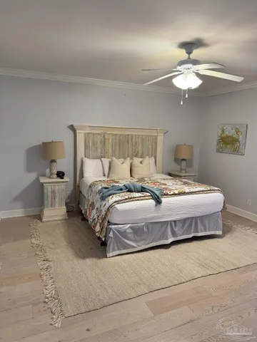a spacious bedroom with a bed and ceiling fan