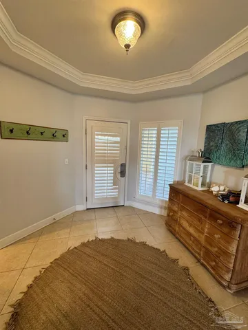 a view of a bedroom with wooden floor and a window
