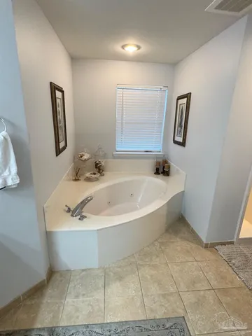 a white bath tub sitting in a bathroom