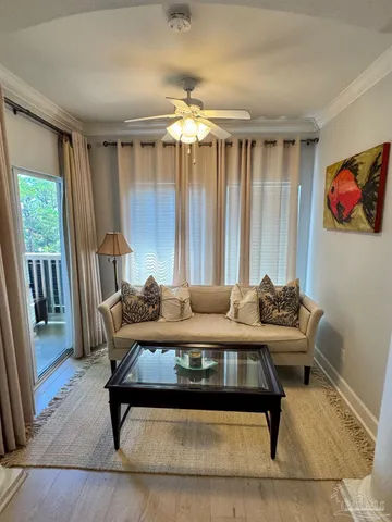 a living room with furniture and a chandelier