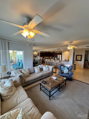 a living room with furniture a chandelier and a piano