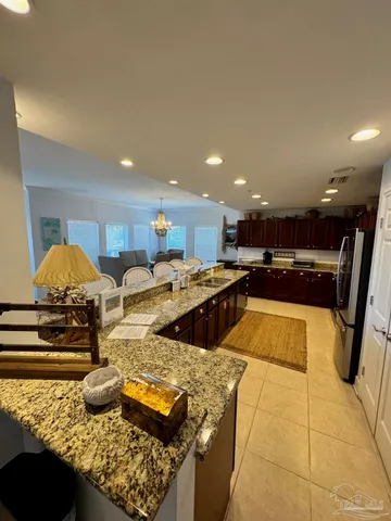 a kitchen with stainless steel appliances granite countertop a sink and a stove