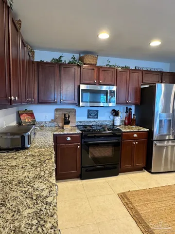 a kitchen with a refrigerator stove top oven and sink