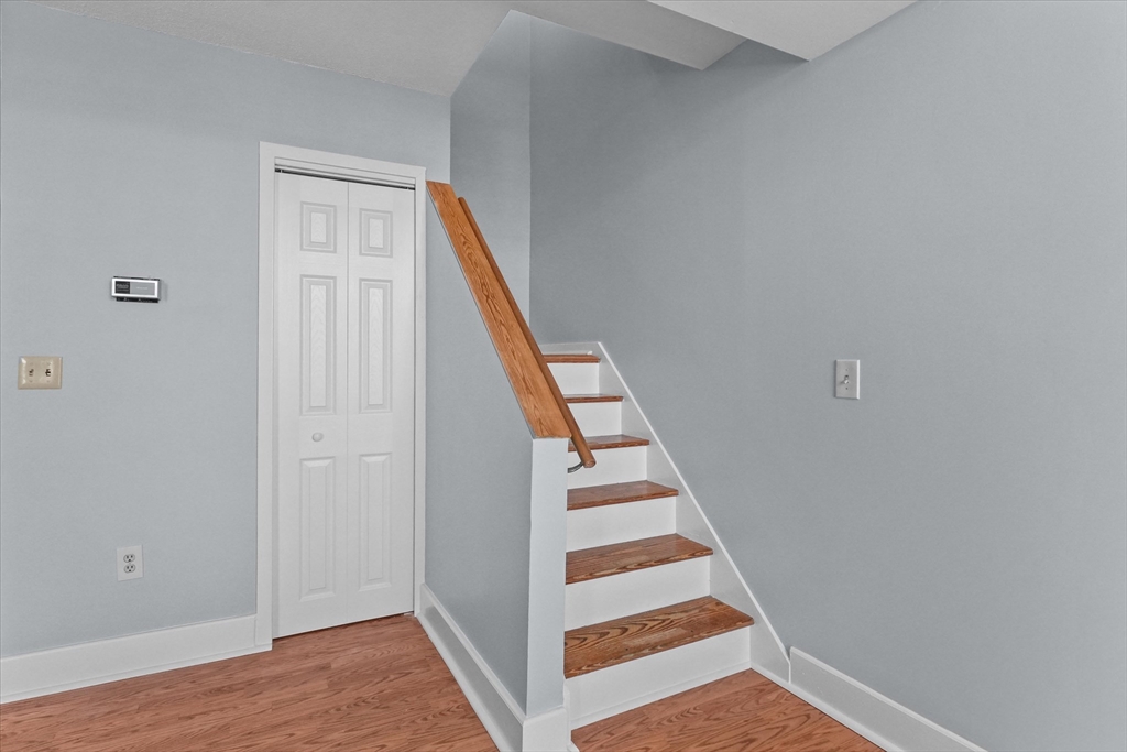201 Thorndike Street, Unit 123 Lowell, MA 01852 - Photo 12 of 28 a view of staircase with wooden floor and white walls