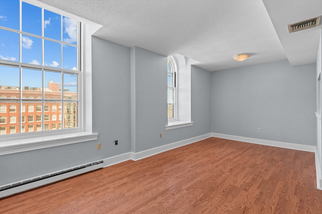 201 Thorndike Street, Unit 123 Lowell, MA 01852 - Photo 8 of 28 an empty room with windows