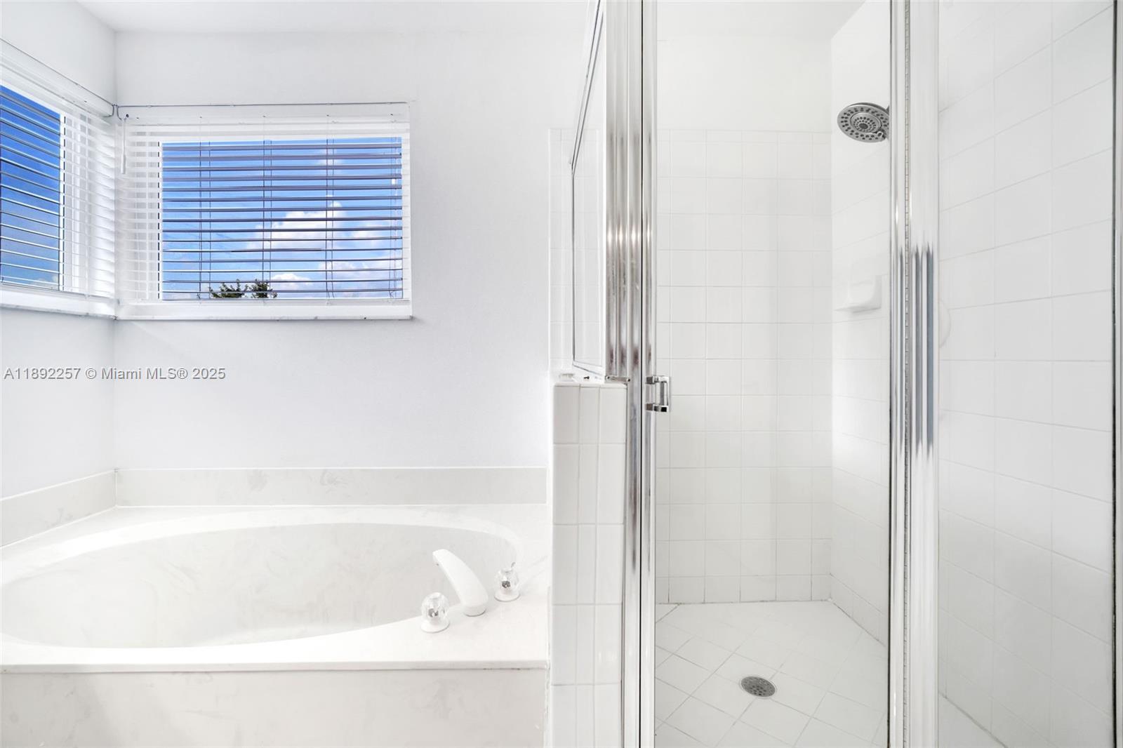 1637 Southwest 156th Avenue Pembroke Pines, FL 33027 - Photo 16 of 27 a bathroom with a bathtub and shower