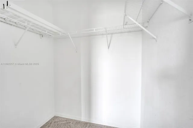 a bathroom with a granite countertop toilet sink and mirror