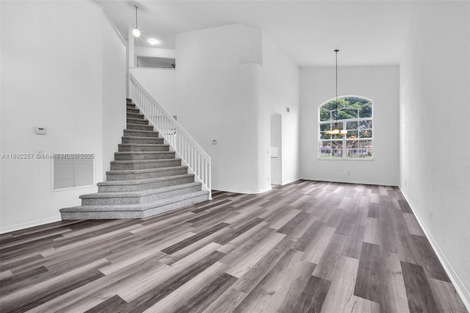 1637 Southwest 156th Avenue Pembroke Pines, FL 33027 - Photo 3 of 27 wooden floor in an empty room with a window