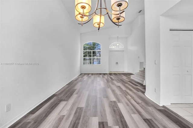 a view of an entryway with wooden floor