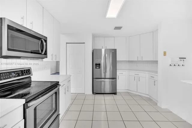 a kitchen with a refrigerator stove and microwave