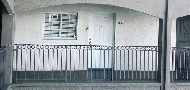 a view of a cars park in front of building